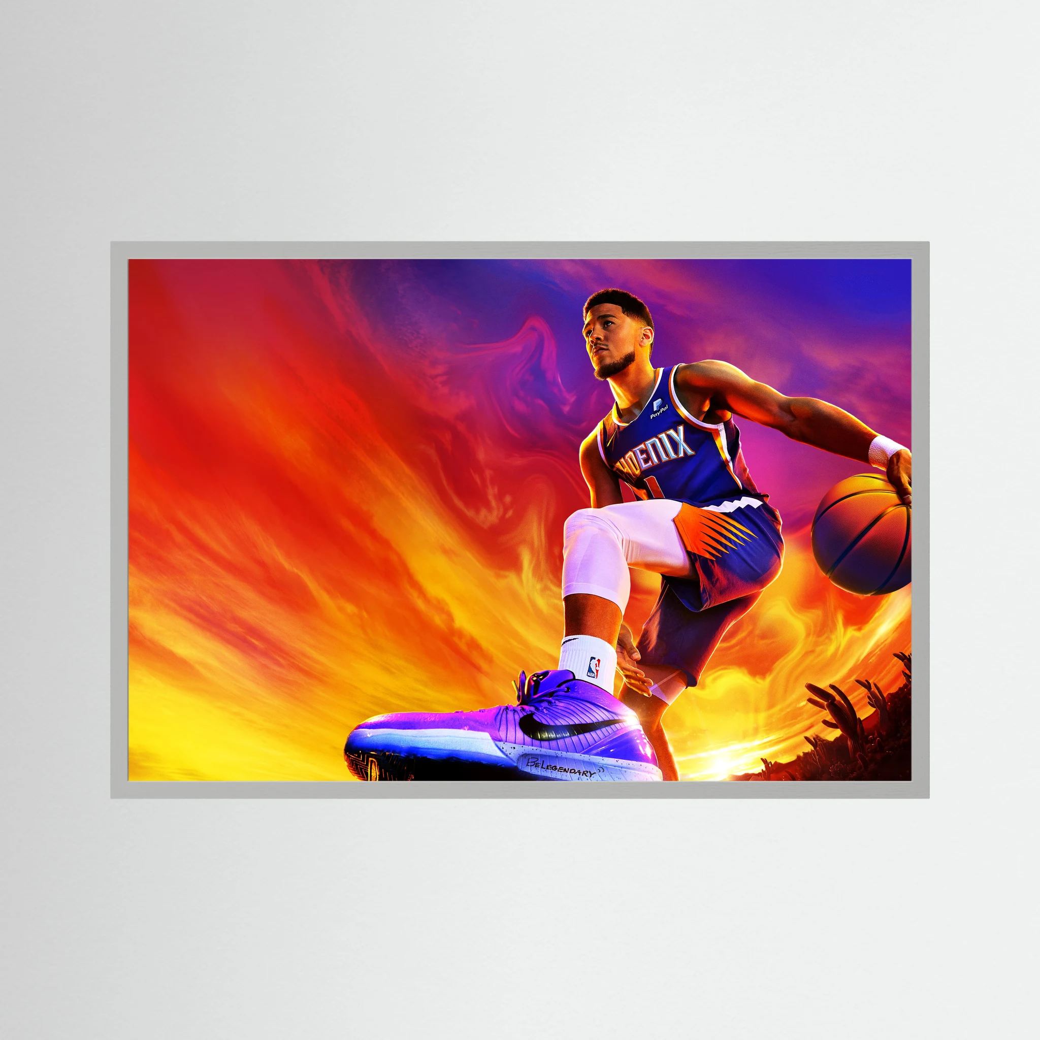 Devin Booker drives with a basketball against an intense orange, purple and blue background, shown in product view 4.
