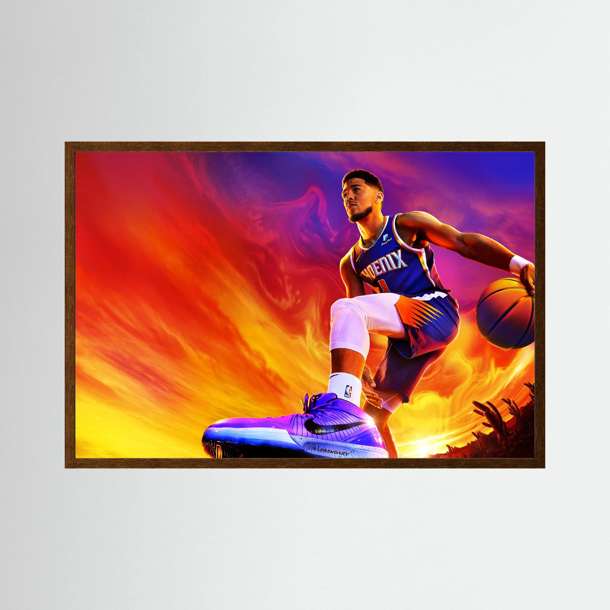 Devin Booker drives with a basketball against an intense orange, purple and blue background, shown in product view 3.