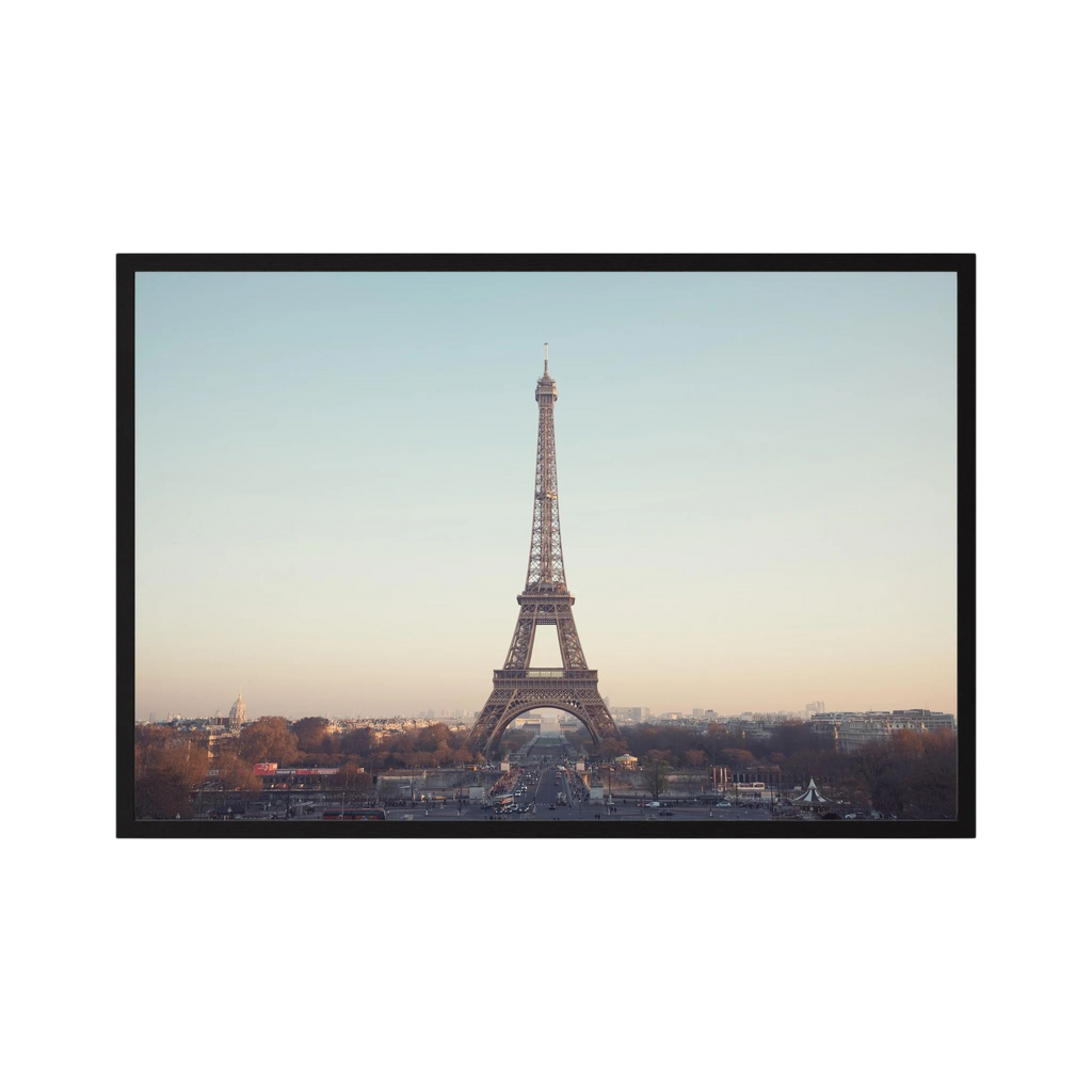 Eiffel Tower photographed across the Paris skyline in soft neutral light.