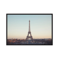 Eiffel Tower photographed across the Paris skyline in soft neutral light.