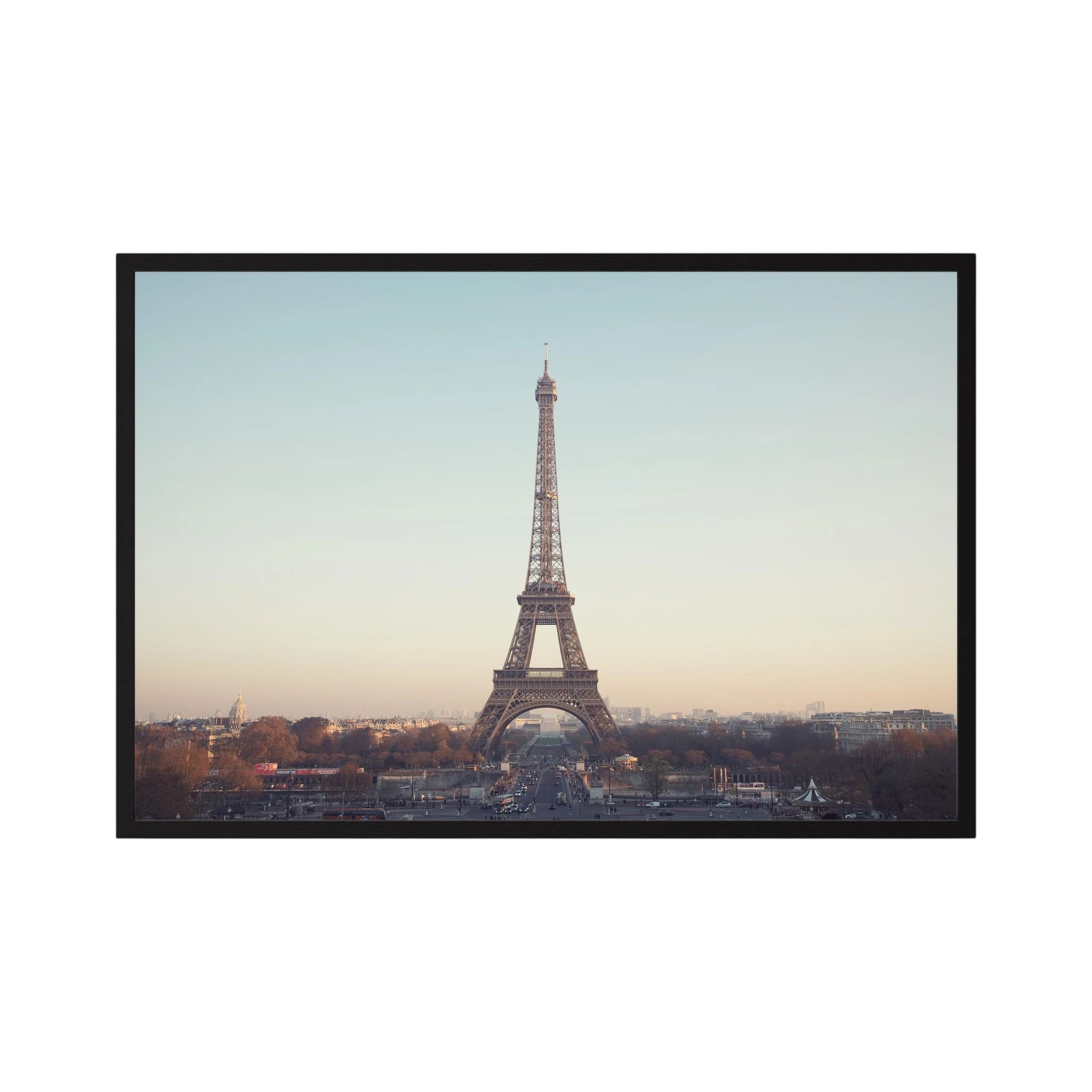 Eiffel Tower photographed across the Paris skyline in soft neutral light.