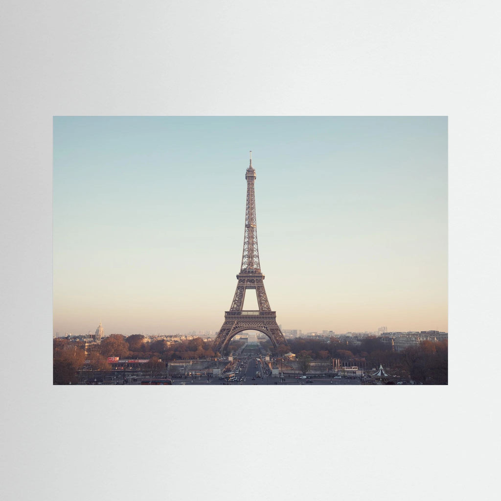 Eiffel Tower photographed across the Paris skyline in soft neutral light.