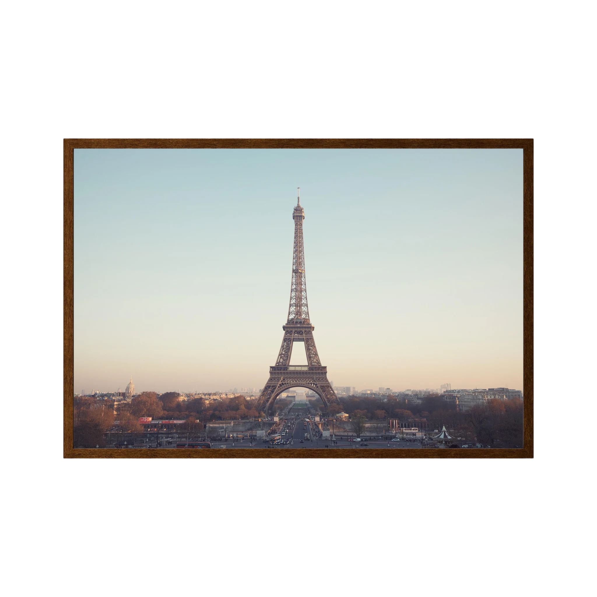 Eiffel Tower photographed across the Paris skyline in soft neutral light.
