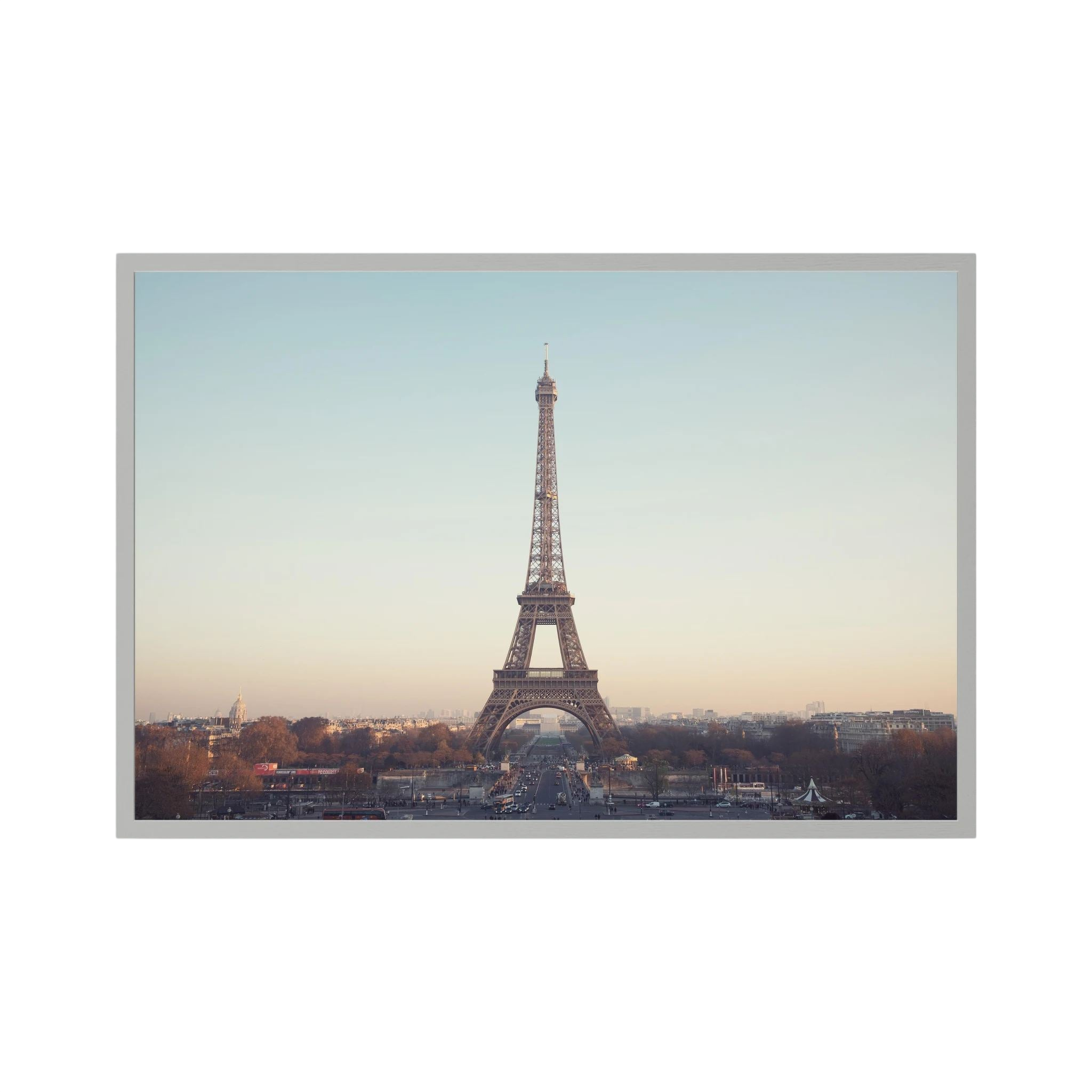 Eiffel Tower photographed across the Paris skyline in soft neutral light.