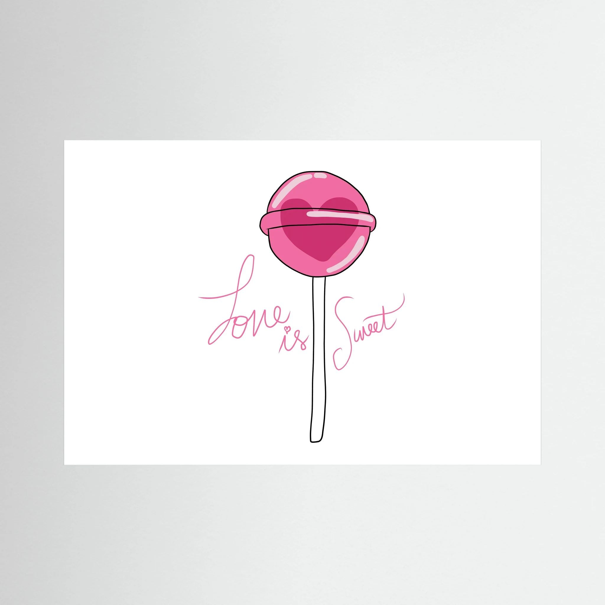 Pink heart-centred lollipop accompanies delicate script reading love is sweet on white, shown in product view 2.